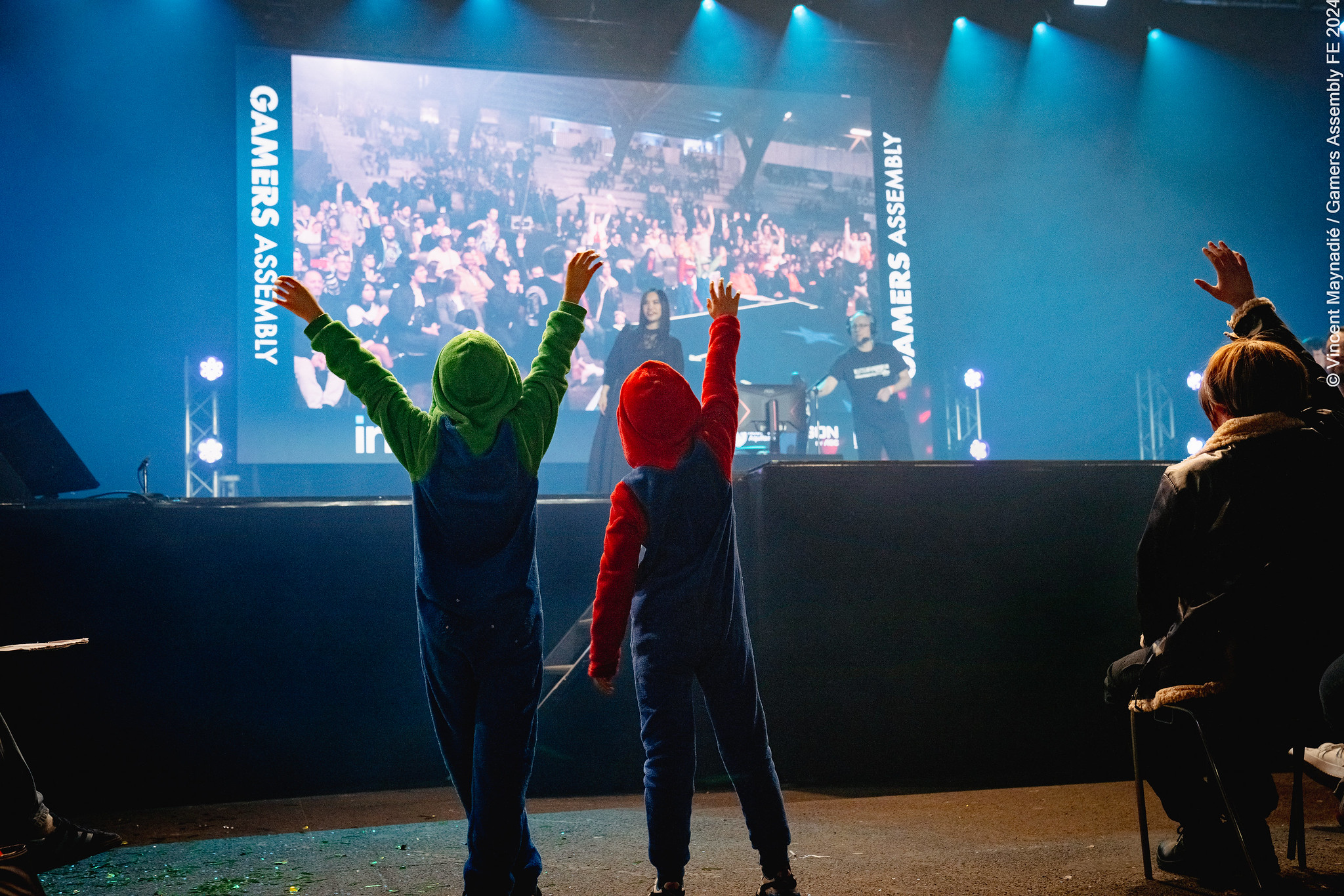 Picture of two boys in front of the Gamer's Assembly central stage.